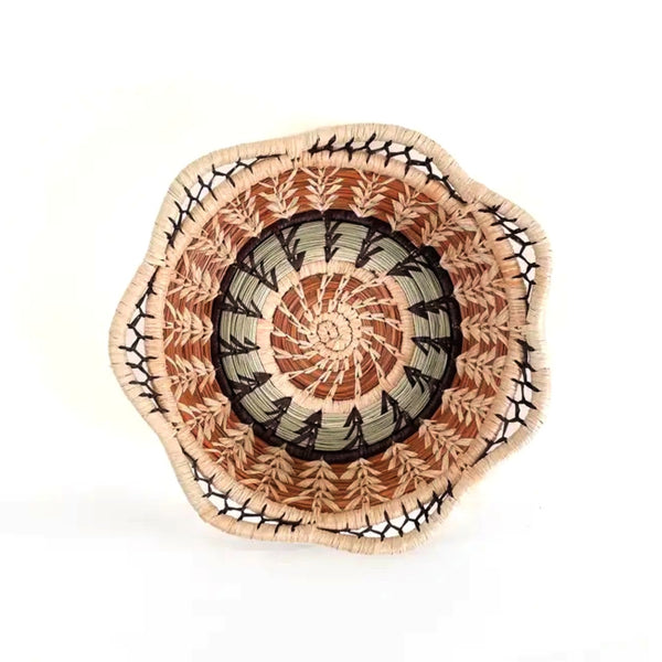 Woven basket with scalloped rim made from pine needles and native grasses, available at Cerulean Arts.  