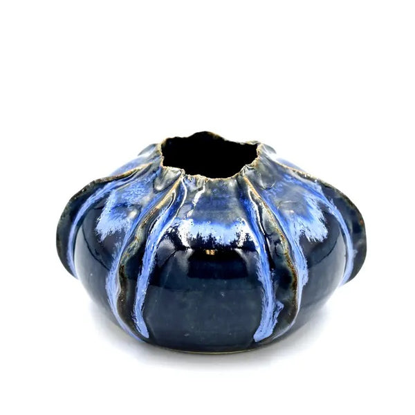 Rose apple shaped porcelain bud vase with variegated deep blue glaze available at Cerulean Arts. 