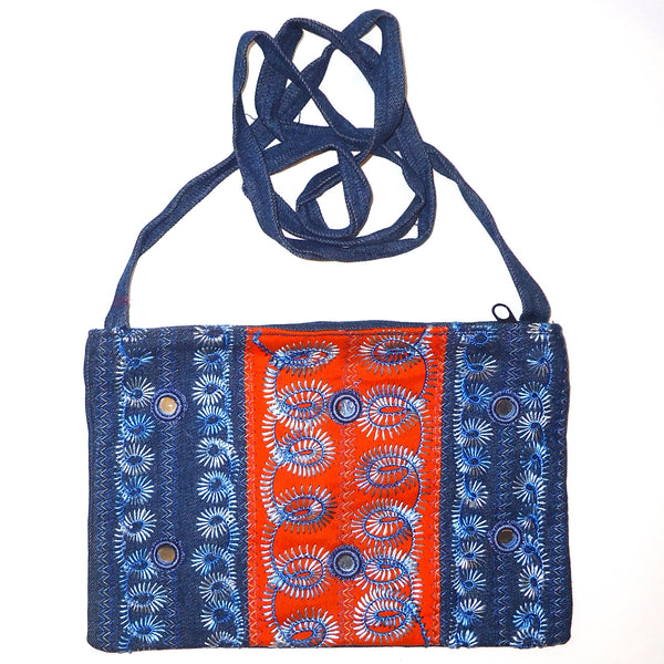 Dark blue and orange denim purse with  embroidery available at Cerulean Arts.