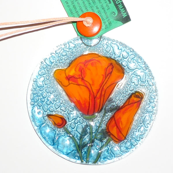 Fused glass suncatcher featuring orange poppy buds, available at Cerulean Arts. 
