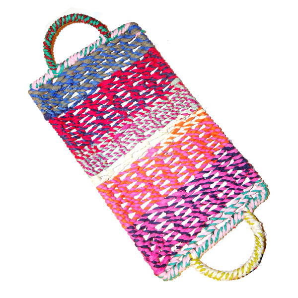 Small, shallow rectangular tray woven in multi-colored jute with handles available at Cerulean Arts. 