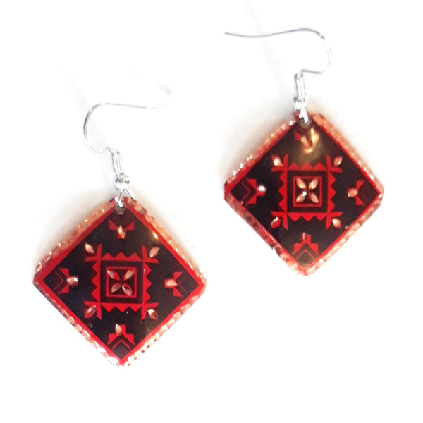 Etched copper geometric earrings with red & black diamond design available at Cerulean Arts.