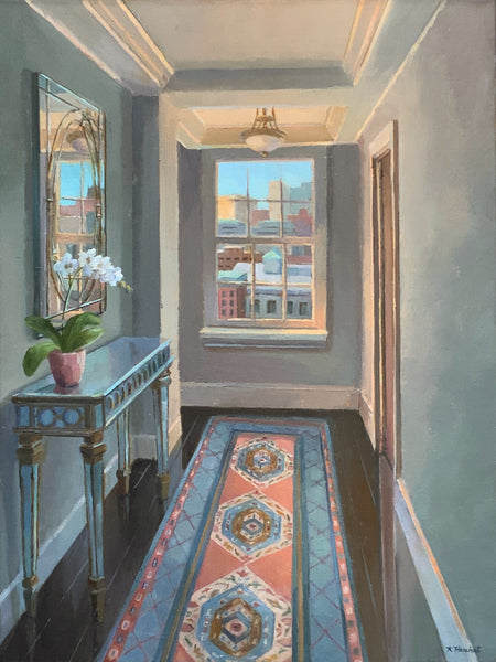 Decorative hallway with a console table, mirror, and colorful rug.