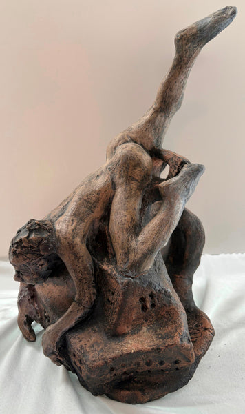 Ceramic sculpture of a falling human figure on a plain background