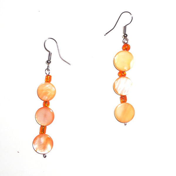 Three iridescent orange drop bead earrings, available at Cerulean Arts.