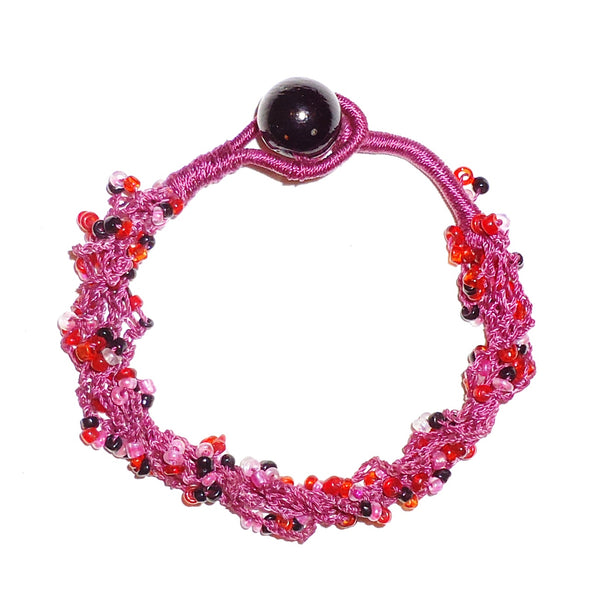 Bracelet with six beaded strands in shades of pink and burgundy, available at Cerulean Arts.