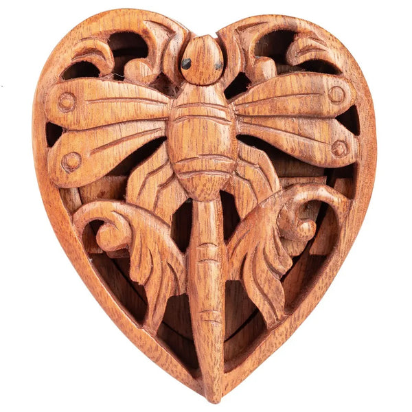 Wooden carvings of a dragonfly and a heart 