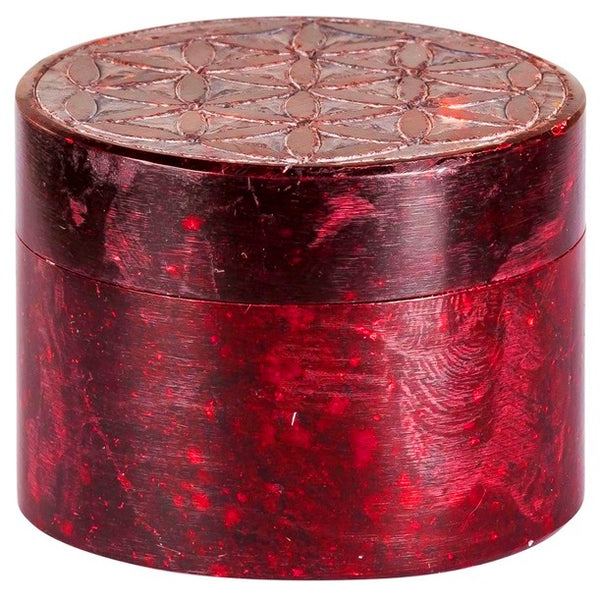 Round soapstone box stained in red carved with flower of life pattern on the lid, available at Cerulean Arts.