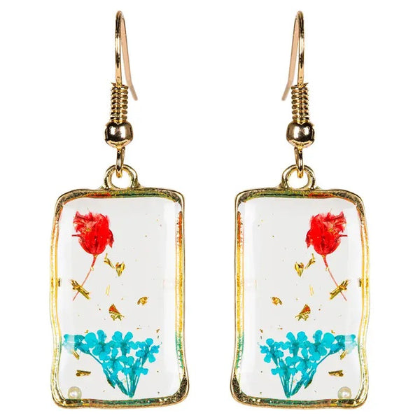 Rectangle earrings with real dried flowers encased in resin with gold colored edging, available at Cerulean Arts.