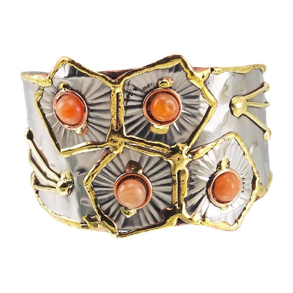 Metal cuff bracelet embellished with four orange stones, available at Cerulean Arts.