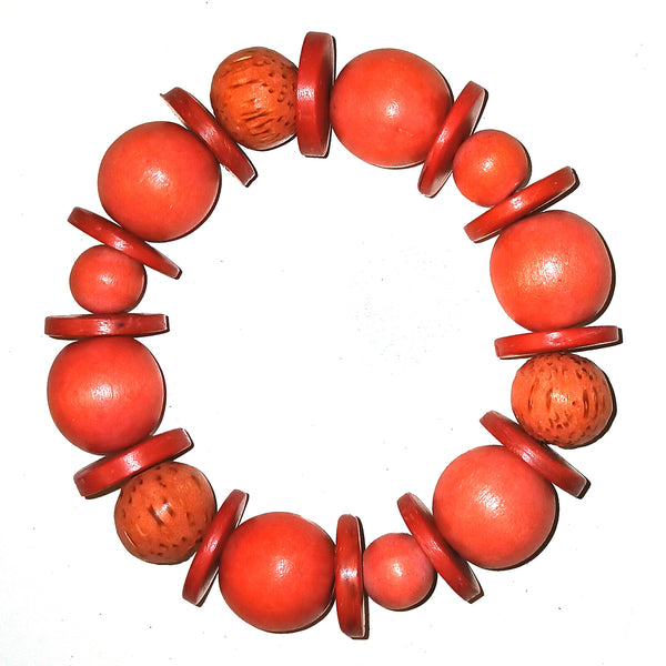 A beaded bracelet made of round coral-red beads and flat matching discs.