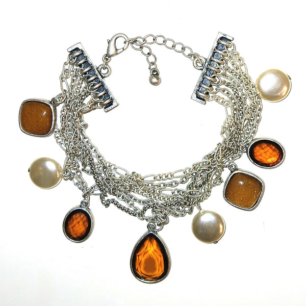 A multi-strand silver chain bracelet featuring amber-colored marquise and square cabochon stones, round coin pearl beads, and a silver toggle clasp.