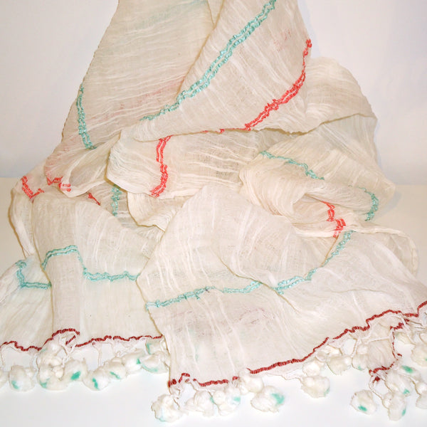 Finely-woven ivory cotton scarf with subtle stripe and playful tassels, available at Cerulean Arts.