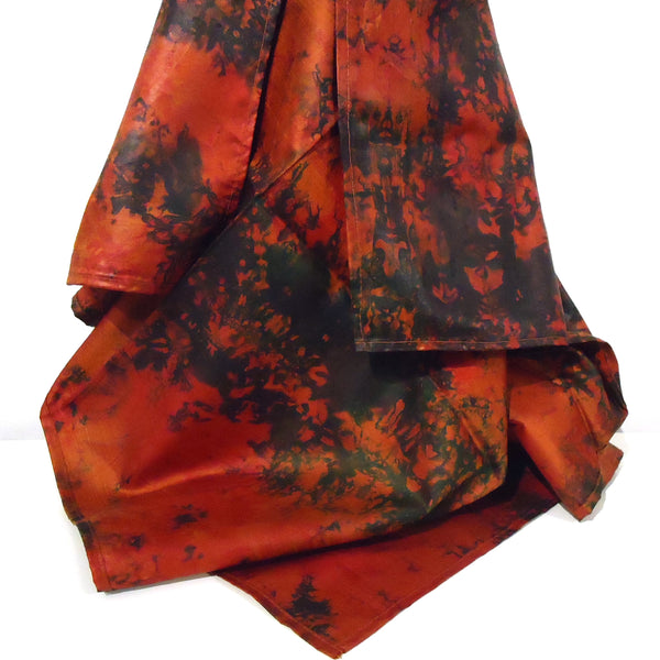 Square batik dyed silk scarf in shades of reds and black,