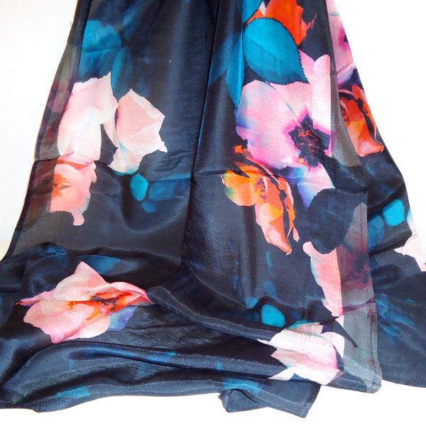 Floral patterned fabric with pink, blue, and orange flowers on a black background