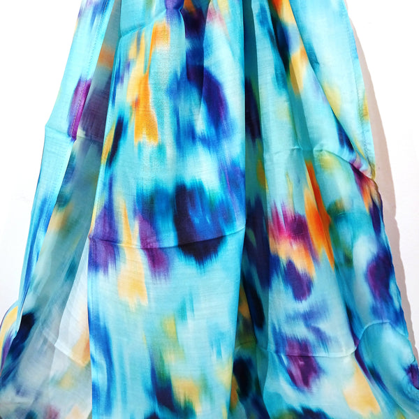 Colorful tie-dye fabric with blue, yellow, and purple patterns