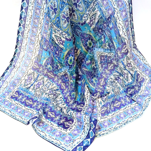 Colorful patterned scarf with blue, green, and white colors 