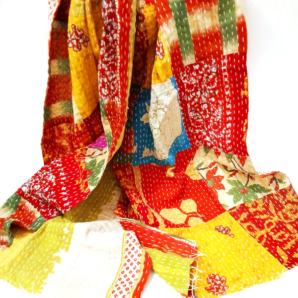 Colorful patchwork fabric with various patterns on a white background