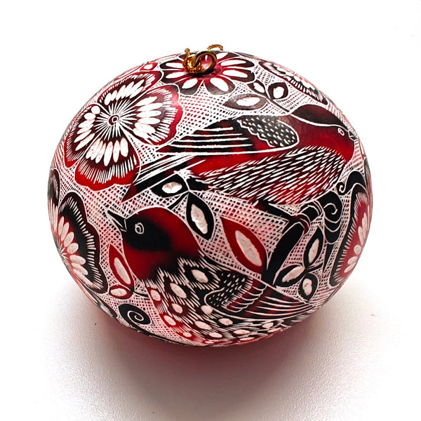 Decorative gourd ornament with intricate black, red, and white patterns of birds