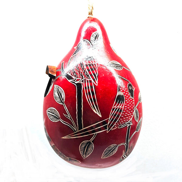 Red decorative gourd birdhouse with black and white bird designs