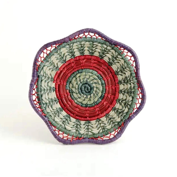 Brightly colored basket with scalloped rim made from pine needles, native grasses and colored raffia accents, available at Cerulean Arts.