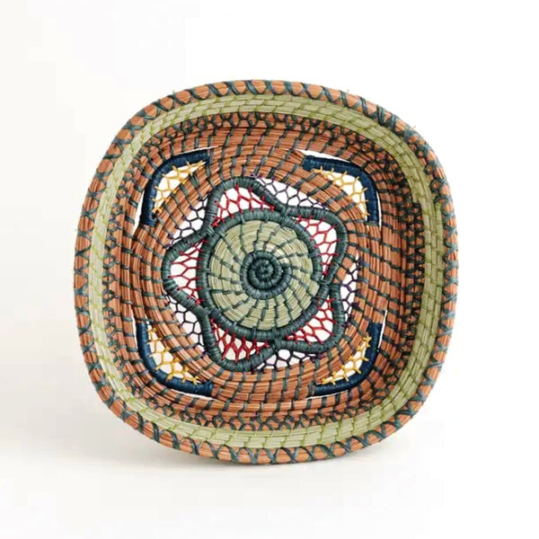 Square basket with elaborate open weave work made from pine needles, native grasses and colored raffia accents, available at Cerulean Arts