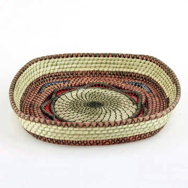 Large square basket with elaborate open weave work made from pine needles, native grasses and colored raffia accents, available at Cerulean Arts.