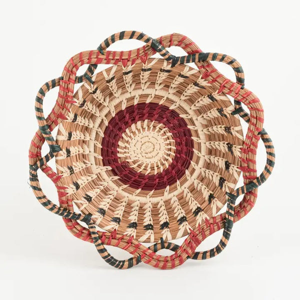 Woven basket with red, black, and beige pattern 