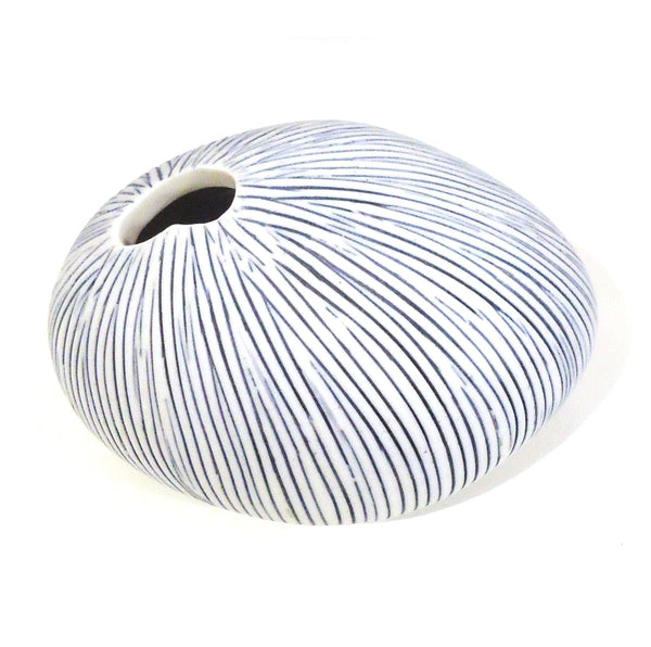 Pebble-shaped porcelain bud vase with fine blue stripes available at Cerulean Arts. 