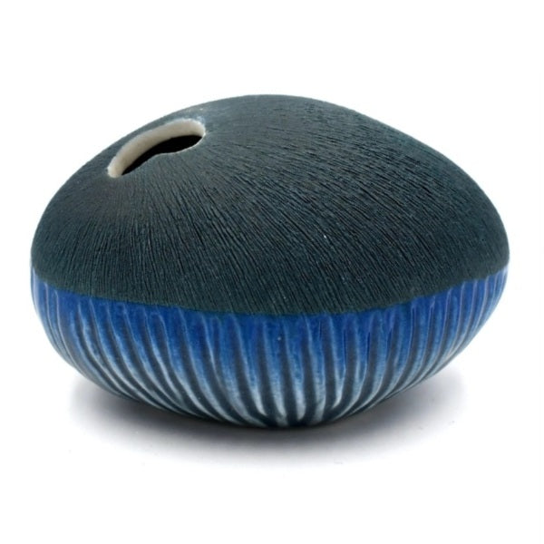 Pebble-shaped porcelain bud vase in navy blue with combination matte / shiny glaze finish, available at Cerulean Arts. 