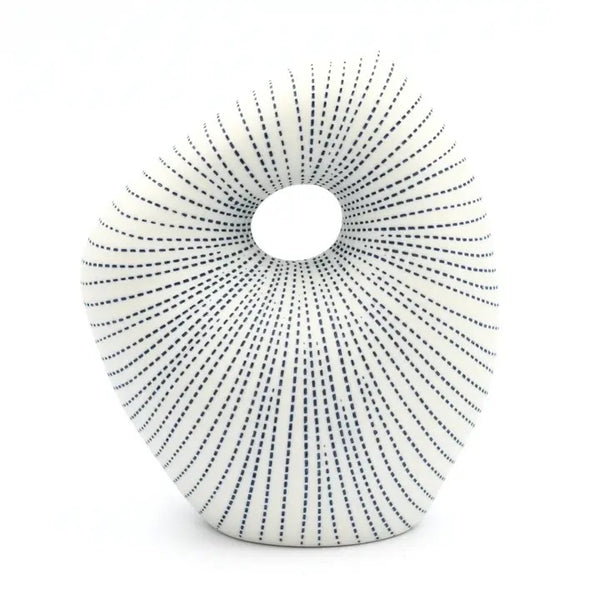 Asymmetrical porcelain bud vase with cutout with blue stipple pattern available at Cerulean Arts