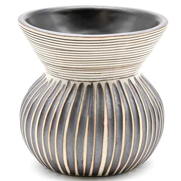A ceramic planter pot with a wide, flared ribbed top and a rounded base featuring vertical ribbed panels, in a dark pewter gray and cream color scheme.