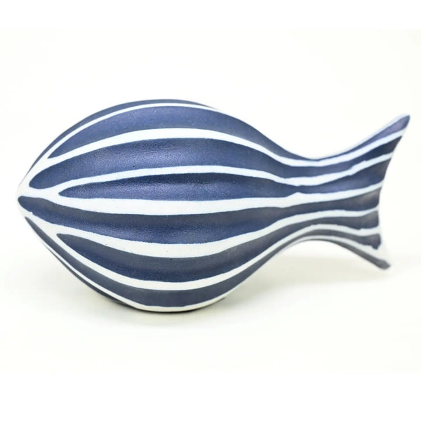 A fish-shaped decorative object with horizontal navy blue and white stripes.