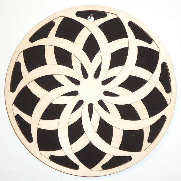 Laser-cut wood pinwheel trivet by veteran Robert E. Jones of Baltic by Design, available at Cerulean Arts.