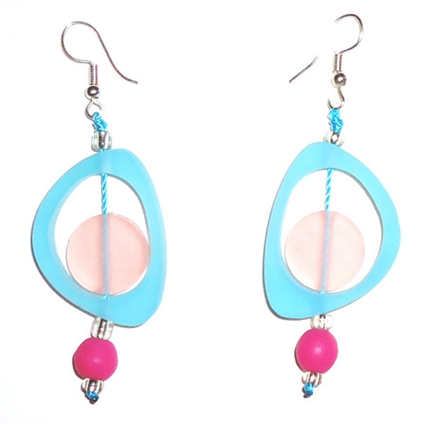 Bold sky blue ovoid resin earrings with pale pink circles, accented with bright pink beads available at Cerulean Arts.  