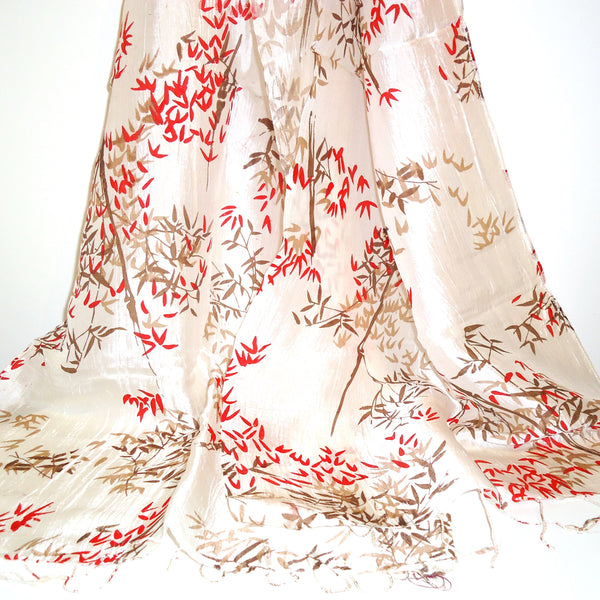 Silk scarf in iridescent white printed with an autumn leaf motif, available at Cerulean Arts.