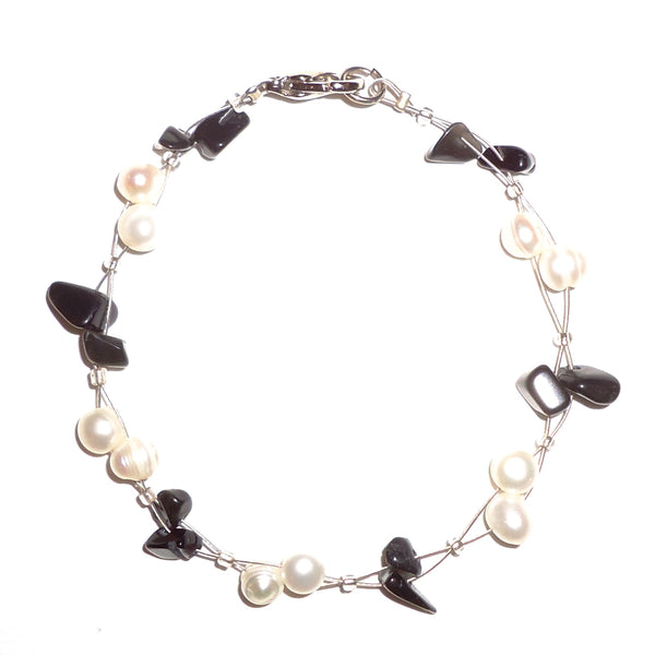 White pearl and onyx chip bracelet on wire cord available at Cerulean Arts. 