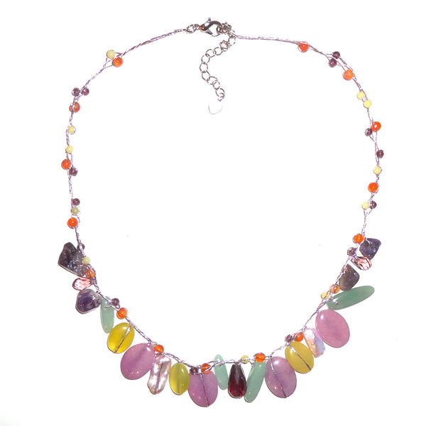 Multi-stone necklace in shades of purple, yellow and green mixed with pearls and crystals on silver silk cord, available at Cerulean Arts.  