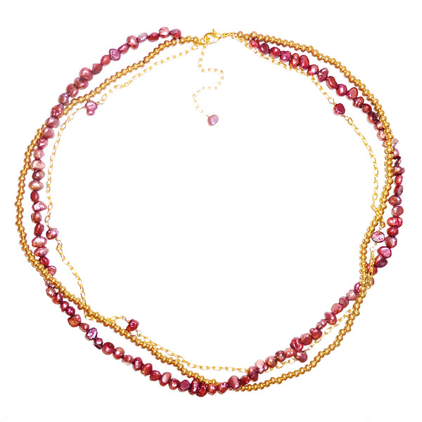 Triple-strand pearl and chain necklace in shades of red and gold, available at Cerulean Arts. 