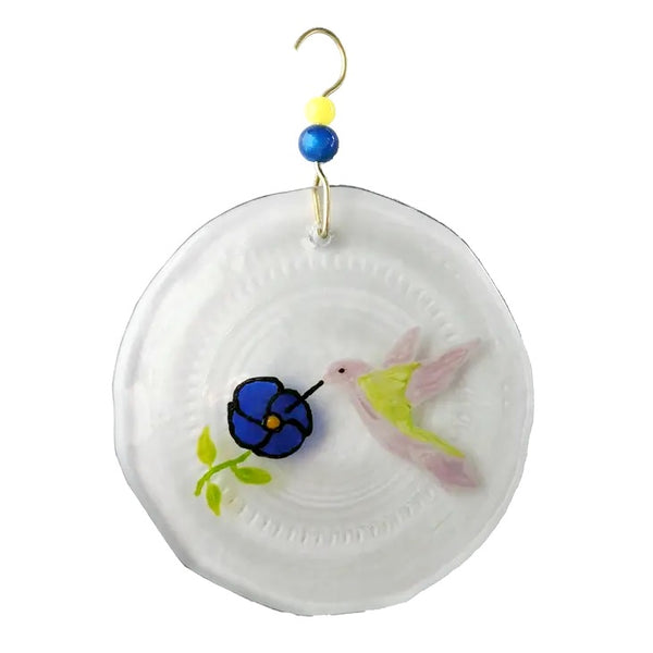 Clear glass suncatcher of a pink hummingbird with blue flower made from a recycled wine bottle available at Cerulean Arts.  