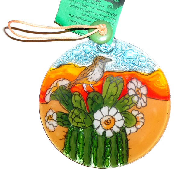 Fused glass suncatcher featuring a flowering cactus with a bird perched atop, available at Cerulean Arts.  