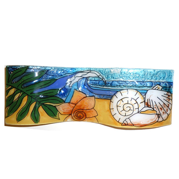 Fused, wavy glass panel featuring an beach scene with seashells, available at Cerulean Arts.