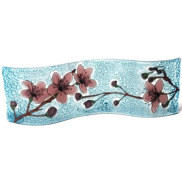 Fused, wavy glass panel featuring a flowering cherry blossom branch, available at Cerulean Arts.