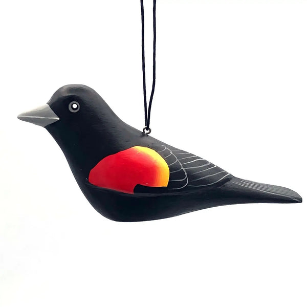 Balsa wood red-winged blackbird ornament hand-carved and painted with non-toxic acrylic paints by a cooperative of artisans on Isla Solentiname, Nicaragua, available at Cerulean Arts.  