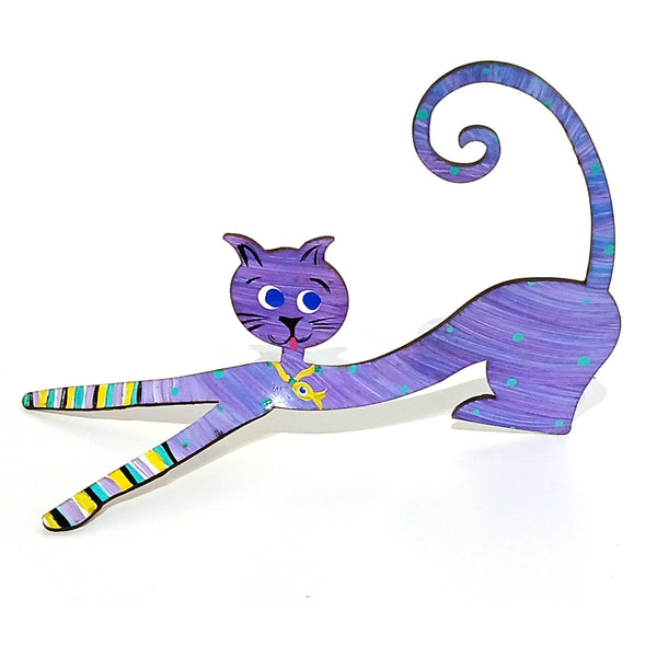A stylized metal cat figurine / photo holder in a stretching pose, decorated with a purple and blue body, multicolor striped paws and tail, and a yellow collar.