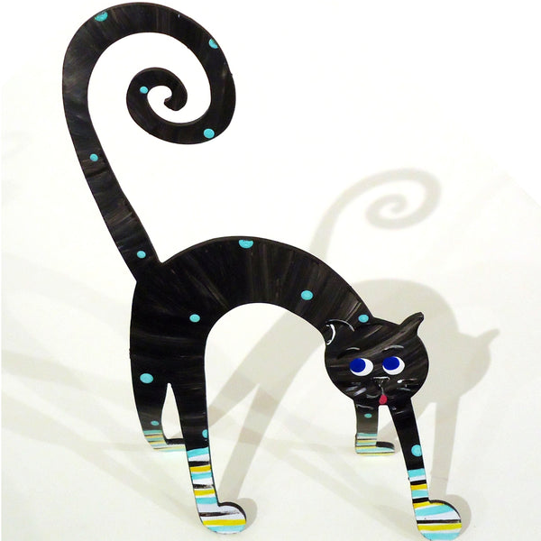 Hand painted steel sculpture of a whimsical cat with arched back in black with polka dots, available at Cerulean Arts.