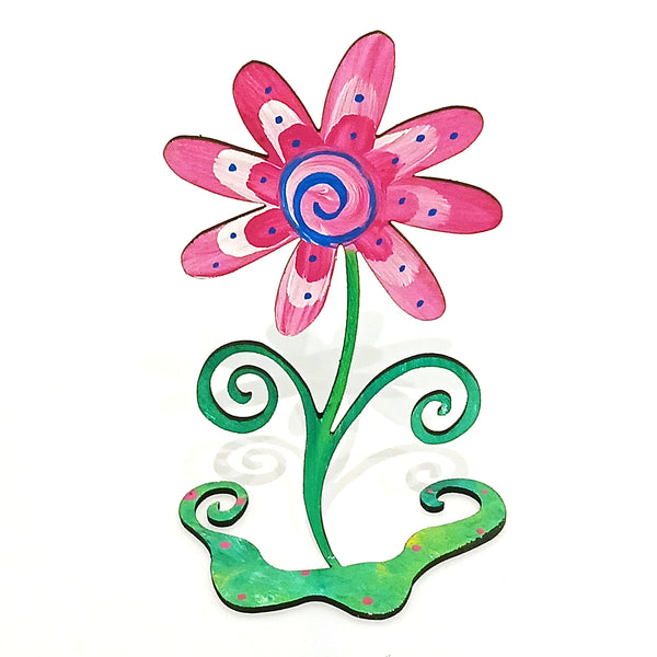 A colorful hand-painted metal flower photo holder with pink petals, a blue and pink spiral center, and a green stem and base with decorative curls.