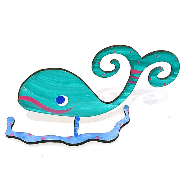 A whimsical whale-shaped figurine / photo holder  in turquoise, blue and pink.