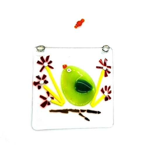 Fused glass suncatcher featuring a yellowbird sitting on a flowering branch, available at Cerulean Arts.