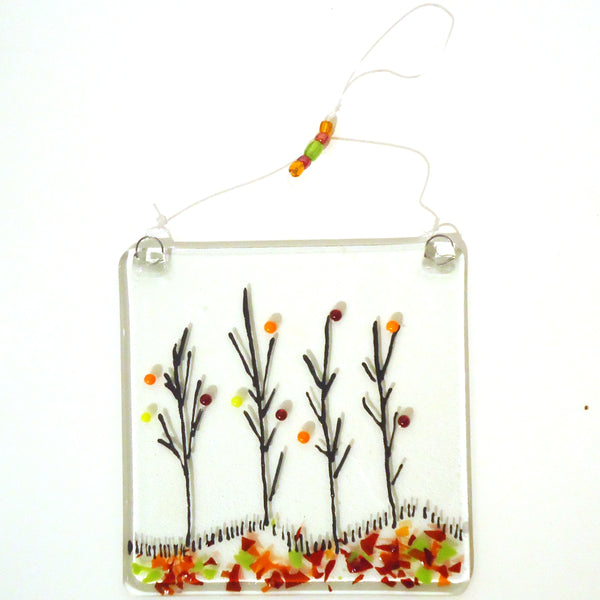 Fused glass suncatcher featuring trees in autumn, available at Cerulean Arts.